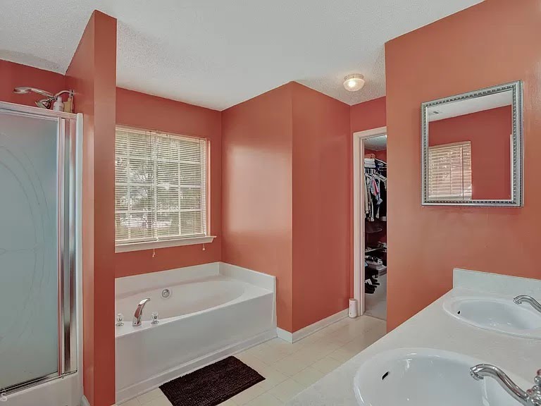 Bathroom with coral walls and white fixtures