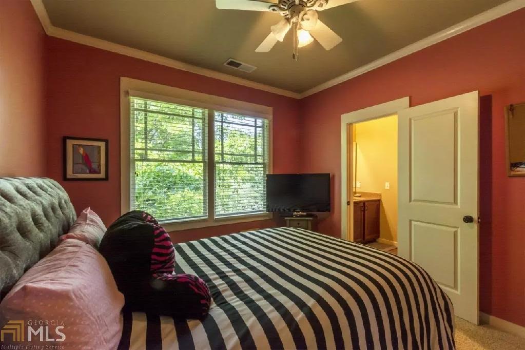Bedroom with coral walls and striped bedding