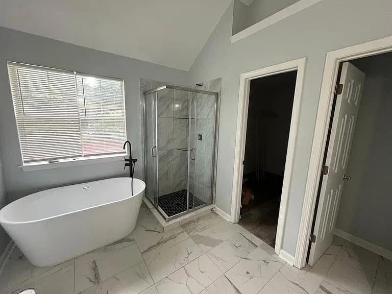 Bathroom with freestanding tub and marble tile