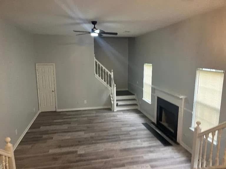 Gray living room with stairs and flooring