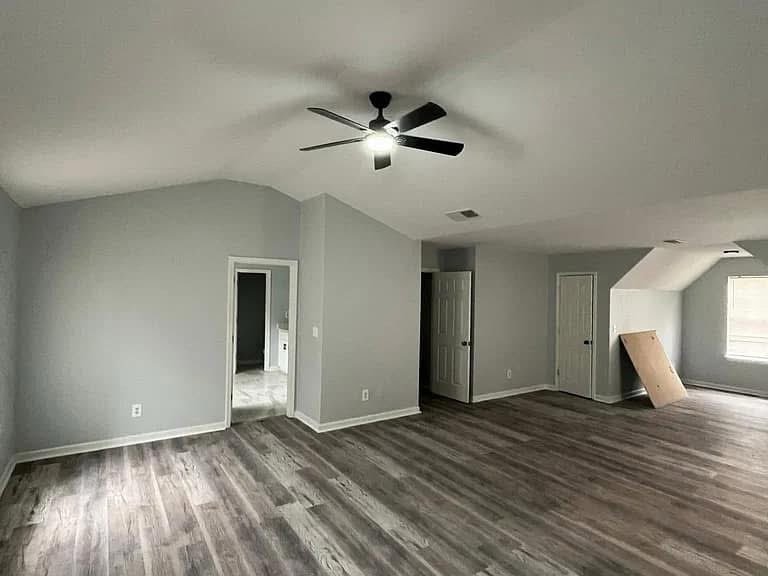 Large gray room with wood-look flooring