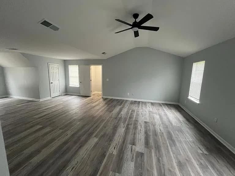 Large gray suite with wood-look flooring