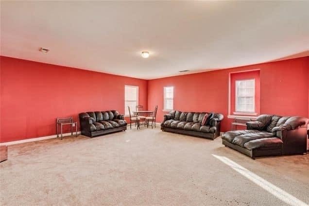 Large room with red walls and seating