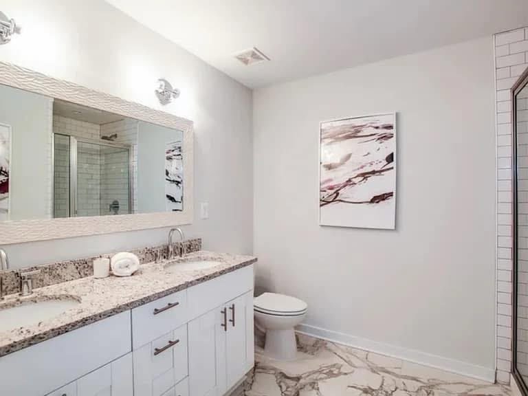 White bathroom vanity with stone counter