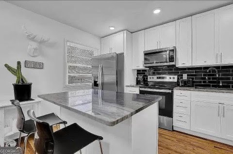 White kitchen with dark backsplash